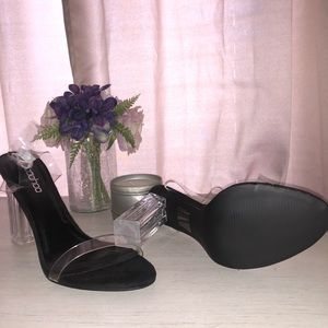 Clear heel black strap around ankle